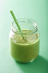 healthy green smoothie with spinach mango banana in glass jars