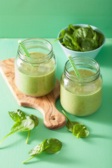 healthy green smoothie with spinach mango banana in glass jars