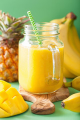 Fototapeta na wymiar healthy mango pineapple smoothie in mason jars