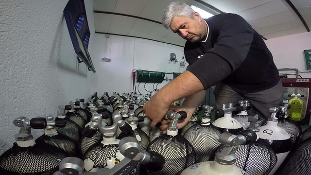 Diver Checking Pressure In Scuba Tank