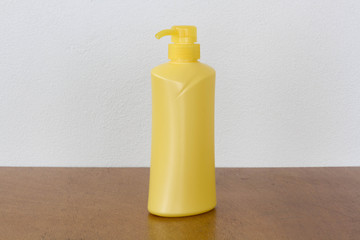 Yellow bottles of health and beauty products cosmetic on the wood