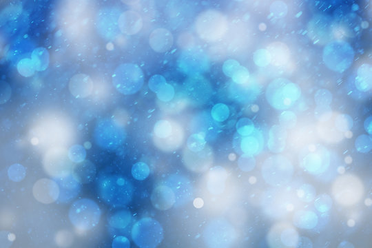 Abstract blurred blue color bokeh with snowfall or rainfall background. Beautiful freshness snowy New Year and Christmas background with copy space background.