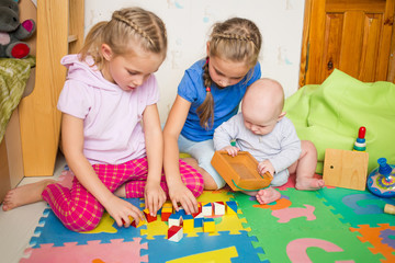 Fototapeta premium Happy kids playing with little brother