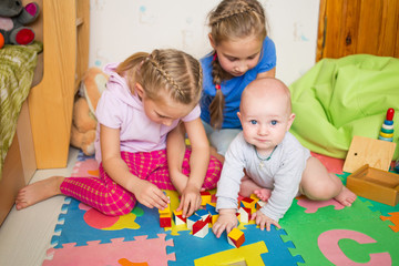 Happy kids playing with little brother