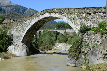 Fototapeta na wymiar Roman bridge at Giornico on Leventina valley, Switzerland