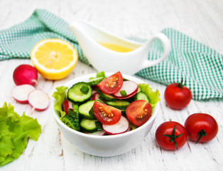 Spring salad with tomato, cucumbers and radish