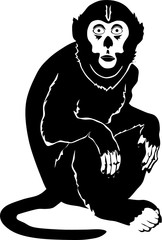 Black silhouette of a monkey sitting on a tree