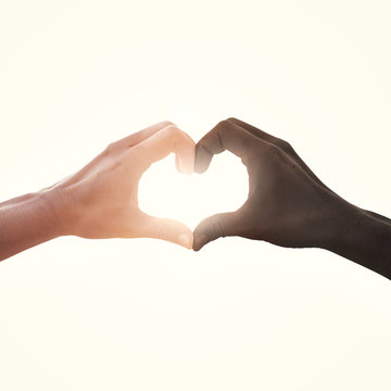 interracial couple in love heart shape hand gesture