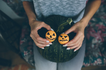 woman holding a biscuit for Halloween