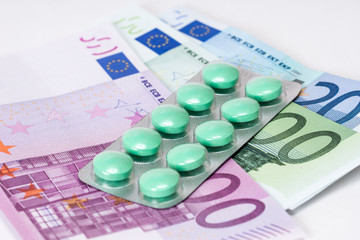 analgesic pills in blister with euro banknotes