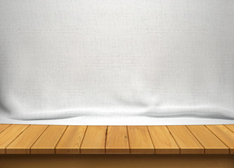 Wood table with white fabric background