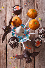 Halloween pop cakes on a table close-up. vertical top view
