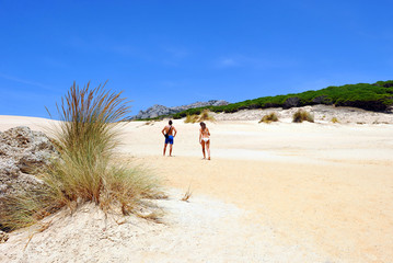 Couple on the dune of Bolonia, Coast of Cadiz, Tarifa, Spain