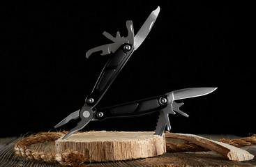 Multitool knife and rope on a dark background