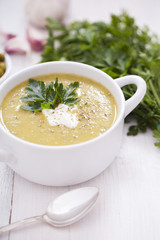 A delicious pea cream with aromatic spices on a wooden table.