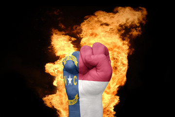 fire fist with the flag of north carolina