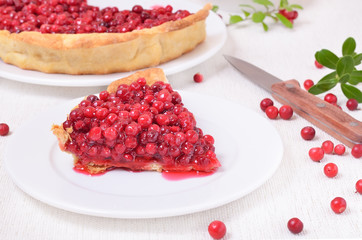 Piece of cowberry pie on white plate