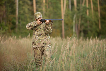 Young male hunter in camouflage clothes ready to hunt  with hunt
