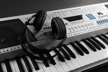 Headphones on synthesizer close up