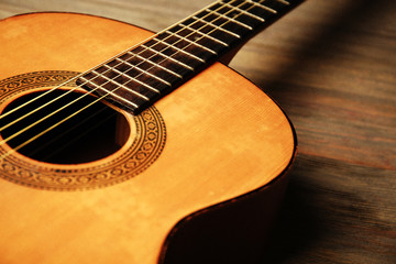 Fototapeta premium Acoustic guitar on wooden background