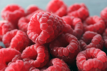 Heap of red sweet raspberries on close up