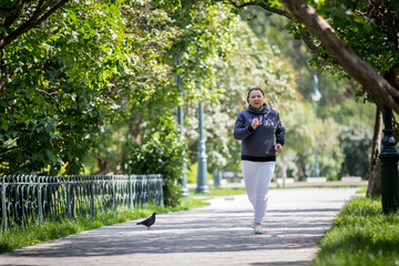 Mature woman jogging in the park. Healthy lifestyle