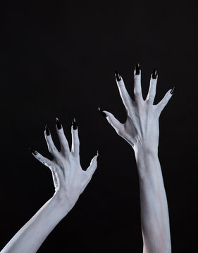 White ghost or witch hands with sharp black nails, body art