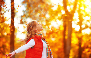 happy girl enjoying life and freedom in the autumn on nature