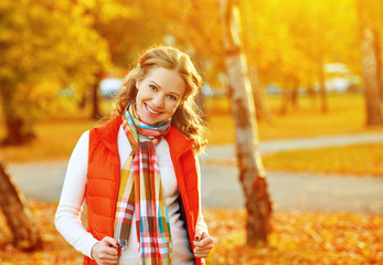 happy girl with autumn leaves on walk