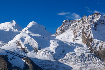 Fototapeta na wymiar Swiss Alps with glaciers against blue sky