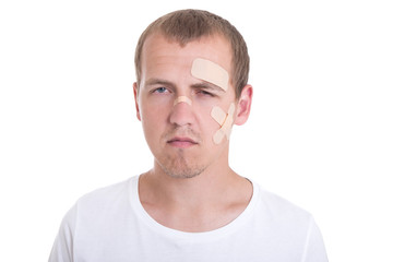 Fototapeta premium sad and injured man with adhesive plaster on his face