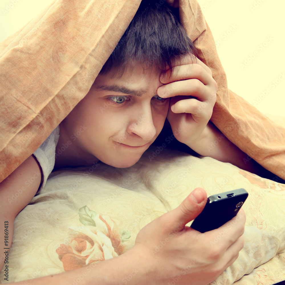 Wall mural Stressed Teenager with Cellphone