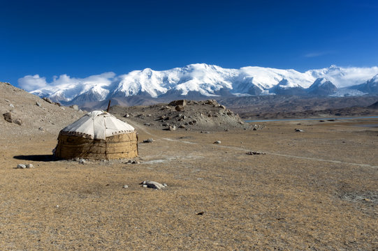 Kyrgyz traditional jurt seen near Karakol Lake, Xinjiang Province, China. Snow mountain-Mt.Muztahgata in the background