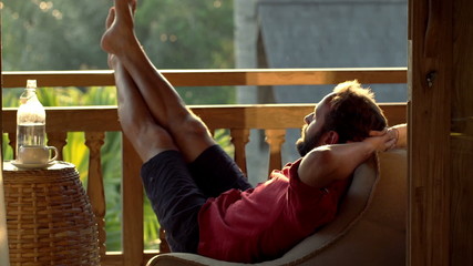 Young man relaxing and sleeping on terrace
 - Powered by Adobe