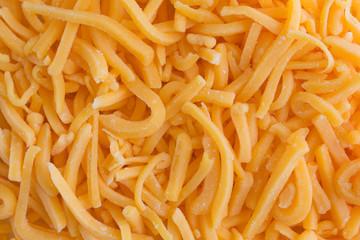 Close view of shredded sharp cheddar cheese