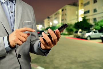 Fototapeta premium Young BusinessMan use Mobile Phone in the Street