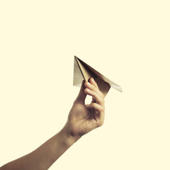 isolated image of a hand starts the paper plane