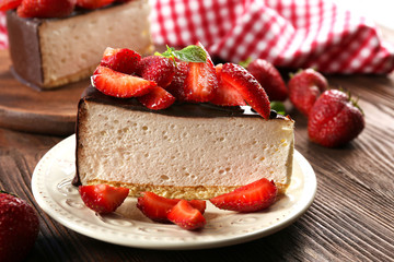 Delicious cheesecake with berries on table close up