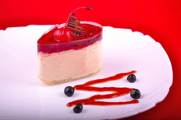 cake with cream at red background