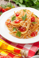 Spaghetti pasta with tomatoes and parsley