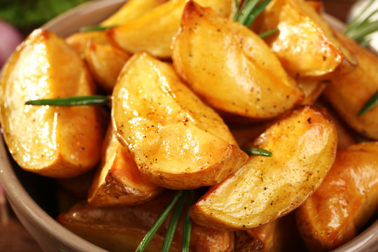 Baked potato wedges in bowl, closeup