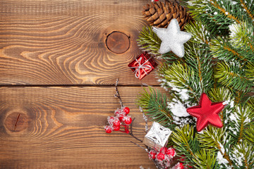 Obraz na płótnie Canvas Christmas wooden background with snow fir tree and decor