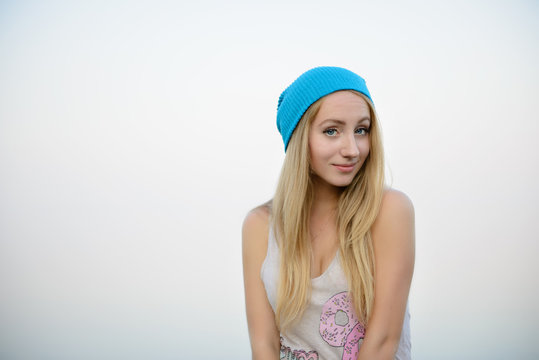 The beautiful girl in a blue cap on walk
