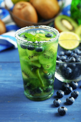 Kiwi and Blueberry cocktail on wooden background