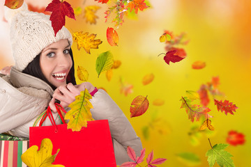 Beautiful woman holding shopping bags, buying in autumn season.