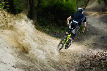 Mountainbiker rides on forest path