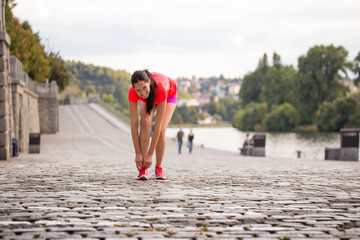 Running woman during sunny day in the city.