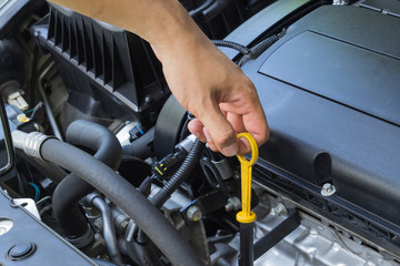 Car repair service, Auto mechanic checking oil level in a engine