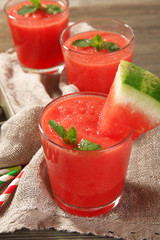 Glasses of watermelon juice on sackcloth, closeup