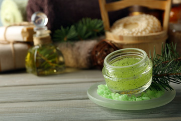 Face scrub and Spa treatments with pine extract on wooden background